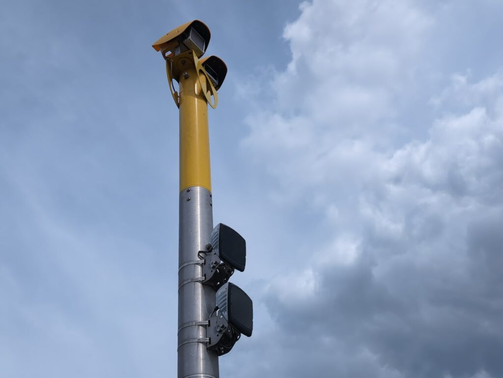A twin-headed AI camera unit on its pole -- the national rollout arriving street by street