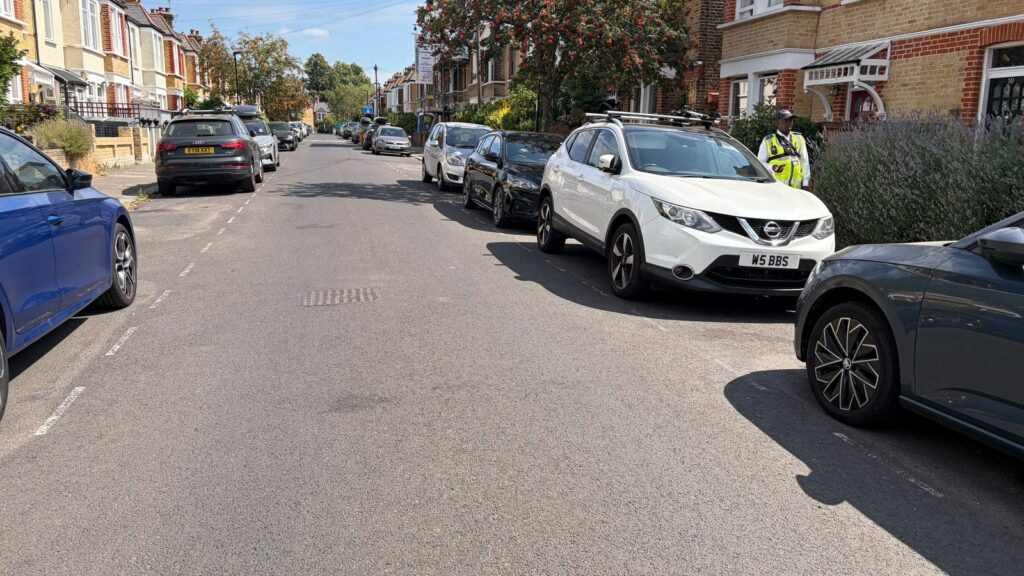 A high-vis volunteer on a residential street -- how Community Speedwatch actually works