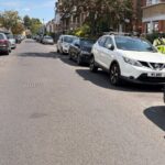 A high-vis volunteer on a residential street -- how Community Speedwatch actually works