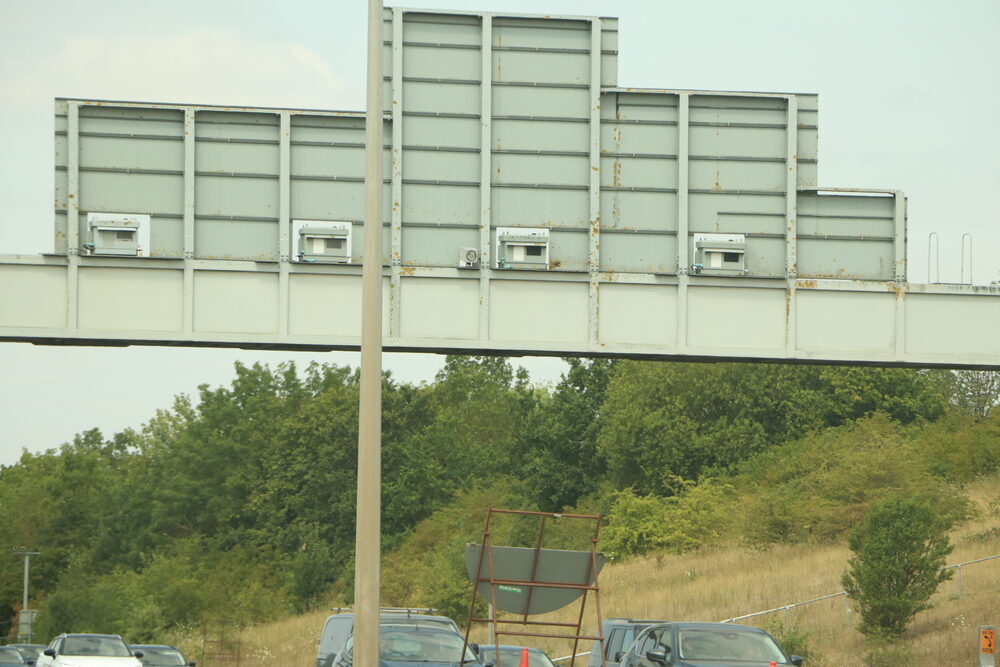 Grey speed camera units on a gantry — speed cameras don't have to be yellow to issue valid fines