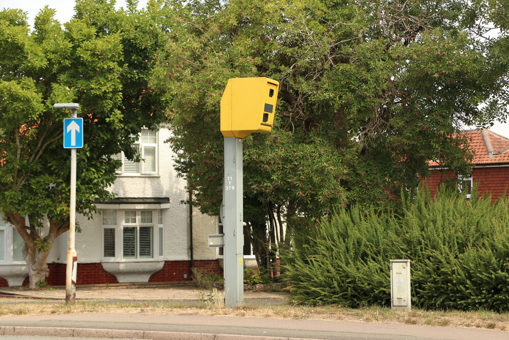 Yellow Gatso speed camera with secondary check lines on the road — key to how convictions are challenged