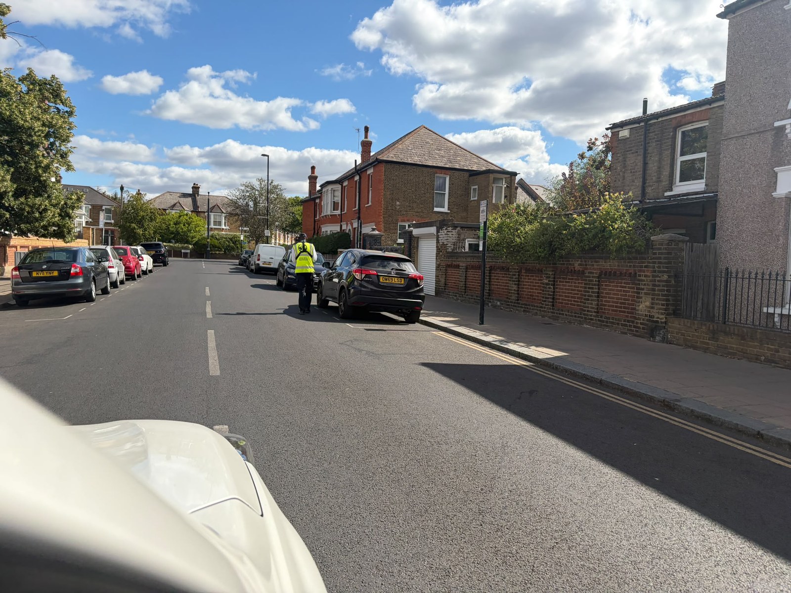 A civil enforcement officer on a residential street -- the LTN fines machine at work